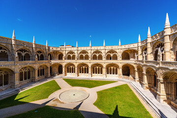 Naklejka premium Cloister of Jeronimos Monastery in Lisbon Portugal with ornate arches and historic Manueline architecture, famous UNESCO landmark and popular travel destination