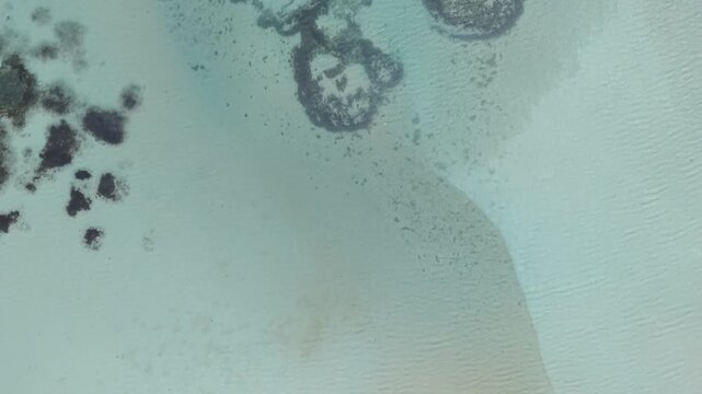Aerial Turquoise Shallow Sea with Sandbar and Dark Reef Patches
