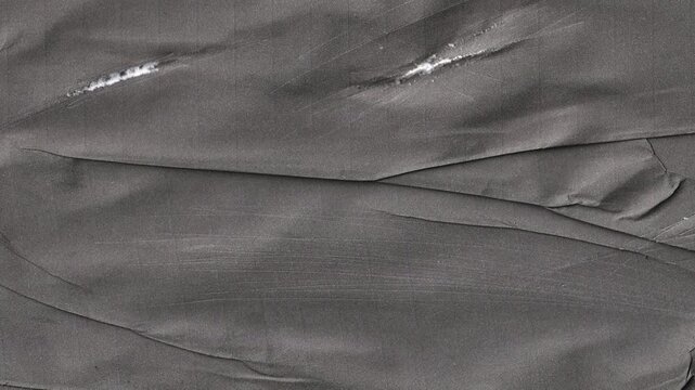 Animated black wrinkled paper texture background with realistic creases and folds for vintage film overlays and creative dark aesthetic video projects for editors.
