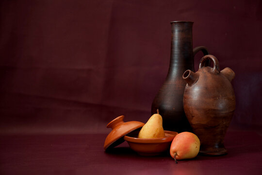Three old clay jars vases &and two pears