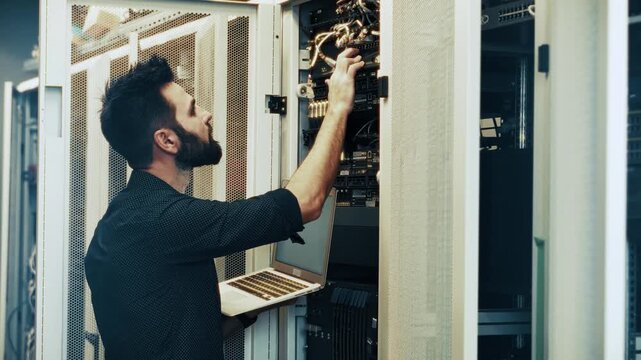 Working in Data Center Server Room. Checking Connection in Mainframe Cabinet. Coder Troubleshooting Information Technology Equipment