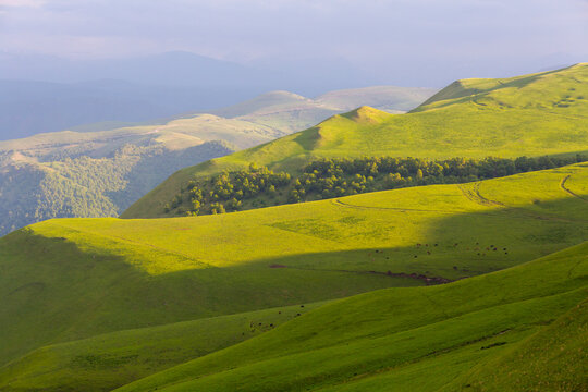 Landscape of green mountain slopes at summer travel in the evening sunlight