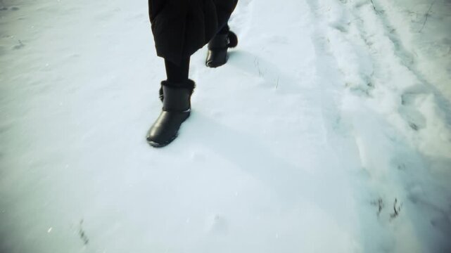 Person Hiking through Snowy Field. Winter Journey and Active Lifestyle in Frosty Weather