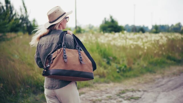Traveler Walking Along Rural Road In Summer Field. Nature Exploration And Leisure Trip In Meadow