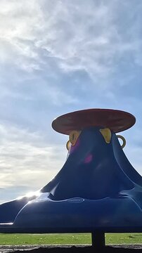 4K Vertical: Spinning Playground Merry-go-round with Blue Sky Copy Space