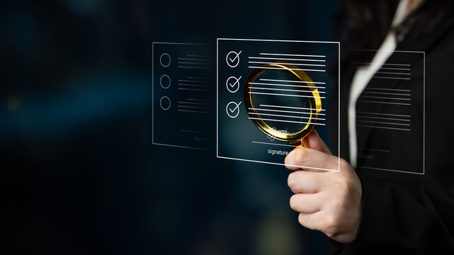 A business professional focuses on a digital checklist using a magnifying glass, symbolizing attention to detail and thoroughness in a modern office setting. Cyphers