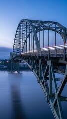 Fototapeta premium Steel arch bridge over calm water.