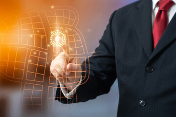 Obraz premium A businessman selects a location on a map to open a business. Business expansion and opening new points of presence. Market analysis and regional growth strategy.