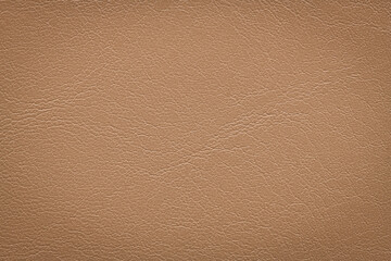 Fototapeta premium Macro shot of a high-quality light brown leather material featuring a fine grained texture and subtle sheen suitable for professional upholstery or fashion design