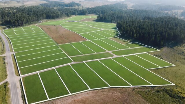 Aerial drone view of a land subdivision with marked plots, serving as a visual concept for real estate development, property sales, and investment opportunities.