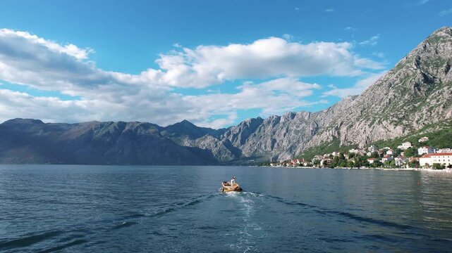 Small boat navigates tranquil coastal waters peacefully. Vessel travels across calm seaside bay under clear skies
