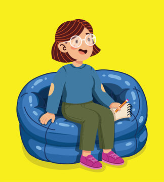 Young woman sitting comfortably in a blue bean bag chair and writing in a notebook.