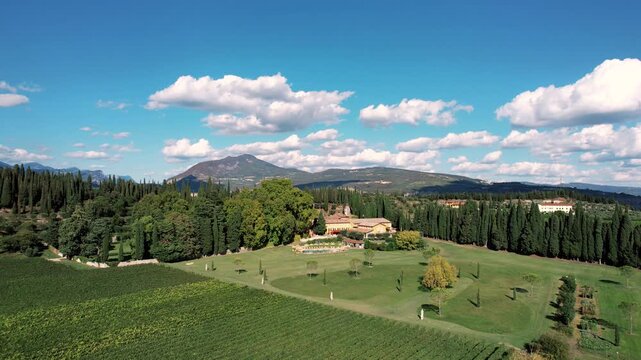 Mountain view landscape. Scenic countryside with vineyards. Remote estate featuring rolling hills and cypress trees