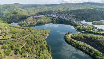 Fototapeta premium Viana do bolo town reflecting on encoro de bao reservoir
