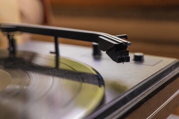 Obraz premium Melodies spin on a vintage turntable in a cozy living room adorned with warm wooden accents