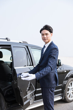 Professional Chauffeur Opening Luxury Car Door