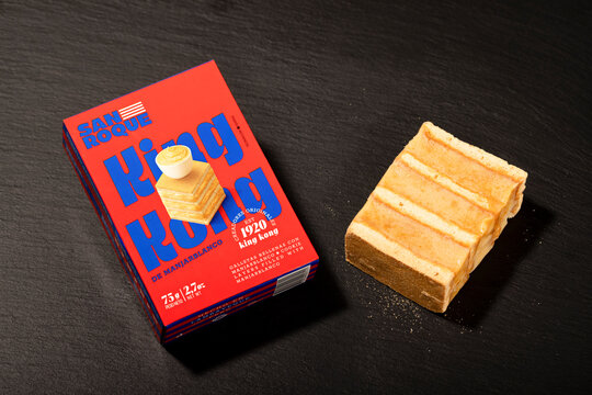 San Roque King Kong turr&oacute;n dessert with layered cookies and manjar blanco filling served with packaging on dark background.