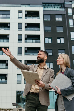 Real estate agents discussing property investment opportunities outdoors