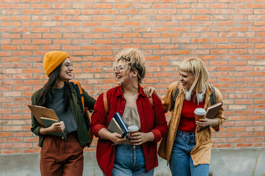 Diverse students walking on campus having fun together