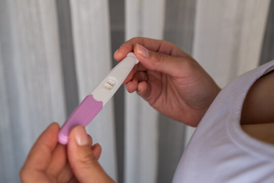 Pregnancy self-test in woman hands at home, medical kit close-up, early result concept, female health care, wellness lifestyle, motherhood preparation, family planning.