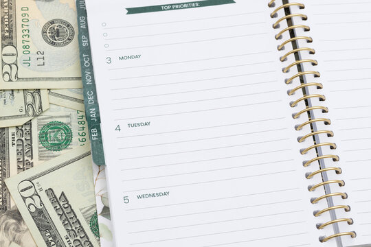 Open day planner notebook on money