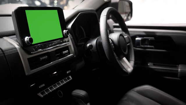Screen or monitor in car mockup with green. Modern car interior with digital infotainment display and green screen mockup. Dashboard technology touchscreen navigation system. smart car interface tech