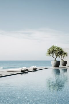 Luxurious infinity pool overlooking endless blue sea with sun loungers and decorative potted trees in minimalist style