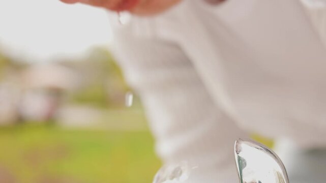 A close-up 4K shot of a man thirst quenching at a water fountain. Highlighting hydration and urban refreshment as part of an eco-friendly lifestyle in city parks. High quality footage