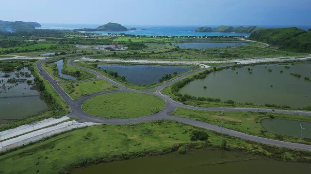 Aerial Mosaic Of Rice Fields And Tidal Lagoons With Intersecting Roads, Coastline And Distant Ocean, Morning Haze And Soft Light Reveal Irrigation Channels And Patchwork Paddies, Ideal