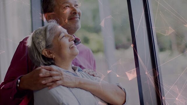 Sunlight streaming through window leading man holding woman leaning back, network overlaying, tech