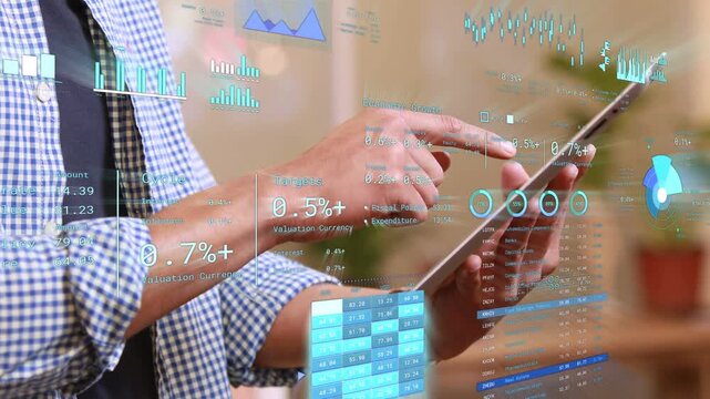Male pro holding tablet and tapping screen, initiating HUD updating and reviewing financial data