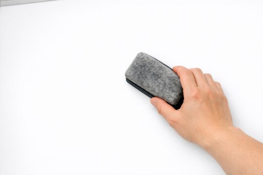A person operating a computer mouse on a white surface