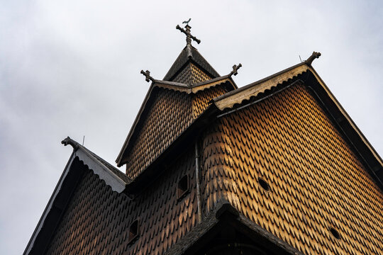 Pagan dragon heads and Christian crosses on the roof of the stave church in Norway. Authentic traditional Norwegian stabbur (raised wooden storehouse) in the rural landscape of Rjukan, Telemark.