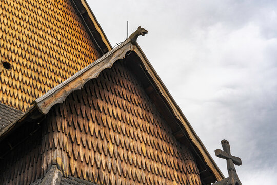 Pagan dragon heads and Christian crosses on the roof of the stave church in Norway. Authentic traditional Norwegian stabbur (raised wooden storehouse) in the rural landscape of Rjukan, Telemark.