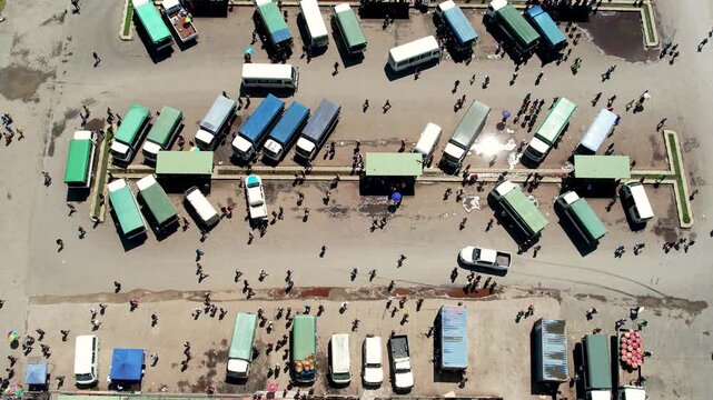 Aerial view of a busy bus terminal with people walking between parked vehicles in Wewak, East Sepik Province, Papua New Guinea.