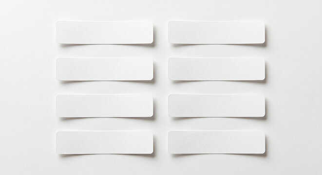 Eight blank white paper rectangles arranged in two columns on white background with flat lay rectangles template copy space background isolated information