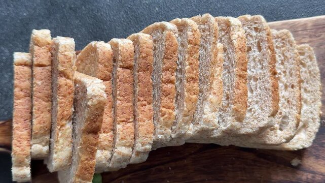Whole-grain bread fresh baked goods, fluffy bread slices tasty snack fresh, delicious, gourmet food background on the table rustic food, top view copy space