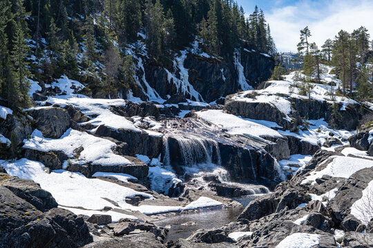 A beautiful waterfall in Norway. Mountain and forest stunning landscape in the background.