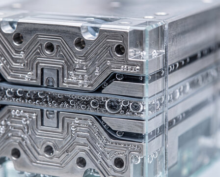 Extreme macro close-up of a hydrogen fuel cell electrolyzer stack with gas bubbles in microchannels