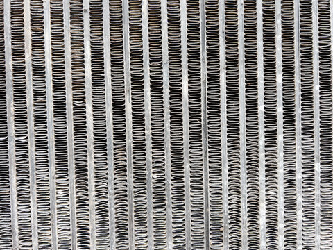 Metal radiator grill creating an abstract industrial pattern and texture