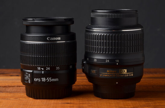 PERPIGNAN, FRANCE - MAY 7, 2026: A Canon EF-S 18-55mm f3.5-5.6 III zoom lens on a wooden surface. This standard kit lens is a common piece of photographic equipment for APS-C digital SLR cameras