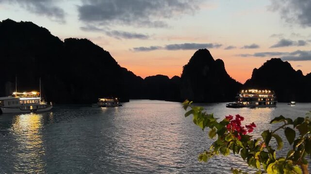 Halong bay sunset with illuminated cruise ships among limestone islands, peaceful evening ocean seascape, travel and tourism destination