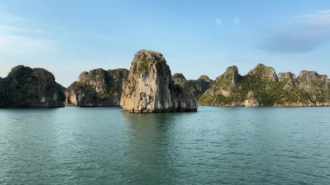 scenic limestone karst formations rising from tranquil waters in ha long bay vietnam, tropical travel, marine seascape, nature vacation