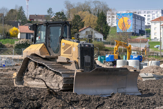 Mirecourt, France - March 21st 2026 : View on a yellow bulldozer CAT D5 for earthworks on a construction site.	