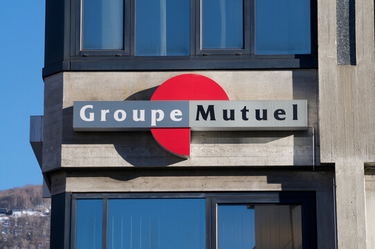 Group Mutuel insurance company sign on building exterior in Lugano, Switzerland