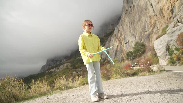 Flexible Acrobatics Girl Juggling Clubs Performing High Split Kick on Mountain Road