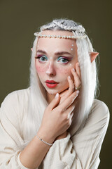 Naklejka premium Beautiful elf girl on dark olive background