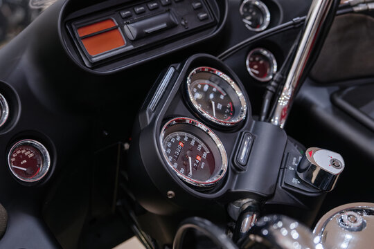Close-up view of motorcycle dashboard featuring a detailed instrument cluster. Prominent speedometer displays approximately 174 MPH, while the odometer reads 32071, showcasing intricate design and