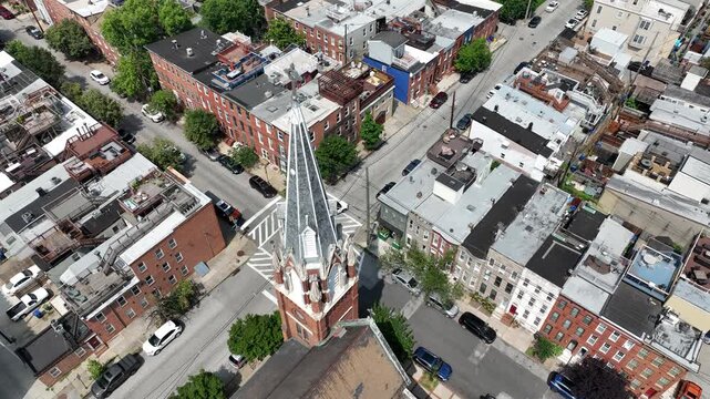 Riverside, Maryland, USA - June 9, 2025: A historic church stands alongside row houses in the beautiful Riverside neighborhood.