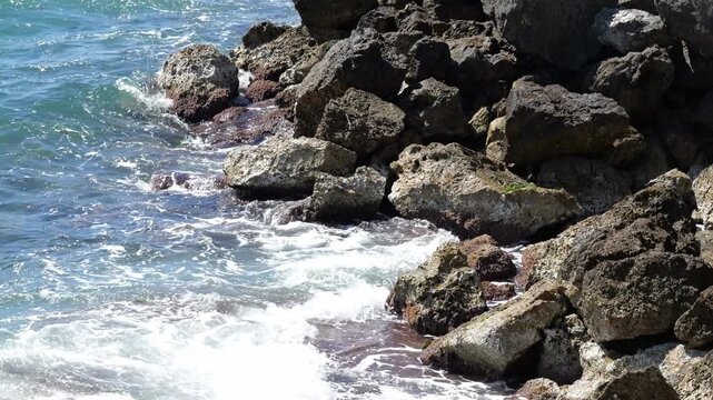 Surf washes over boulders on the coast of Cala Blava in Mallorca. Ideal for nature, travel, or relaxing background videos. 4K UHD (3840x2160), 25fps, 58 seconds, 844 MB.